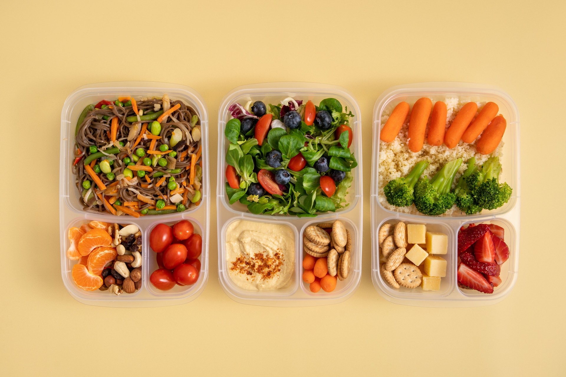 Three plastic containers with prepared lunches